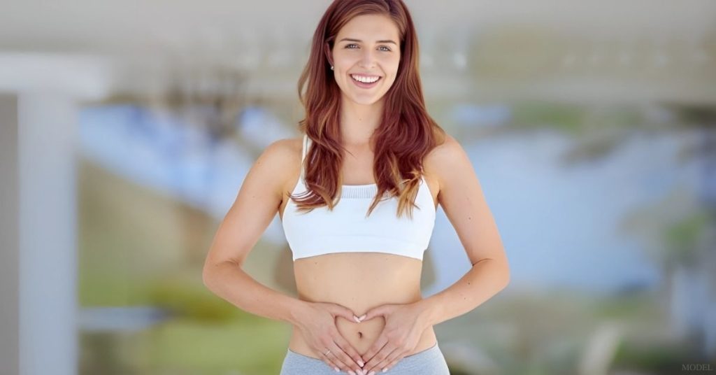 Woman forming a heart shape with her hands (model)