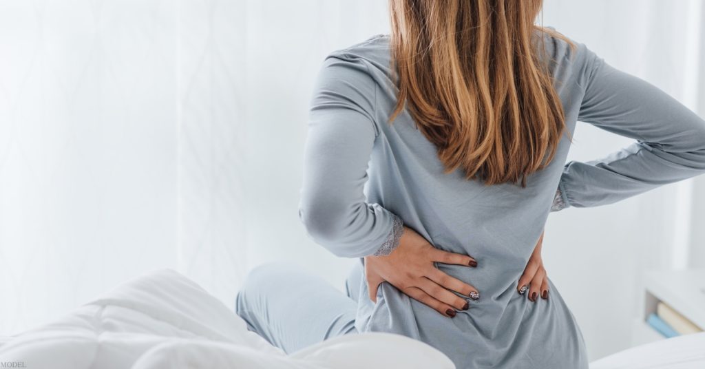 Woman touching her back (model)