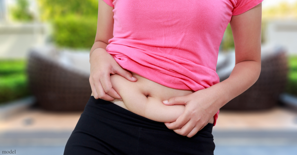 woman holding her belly (model)