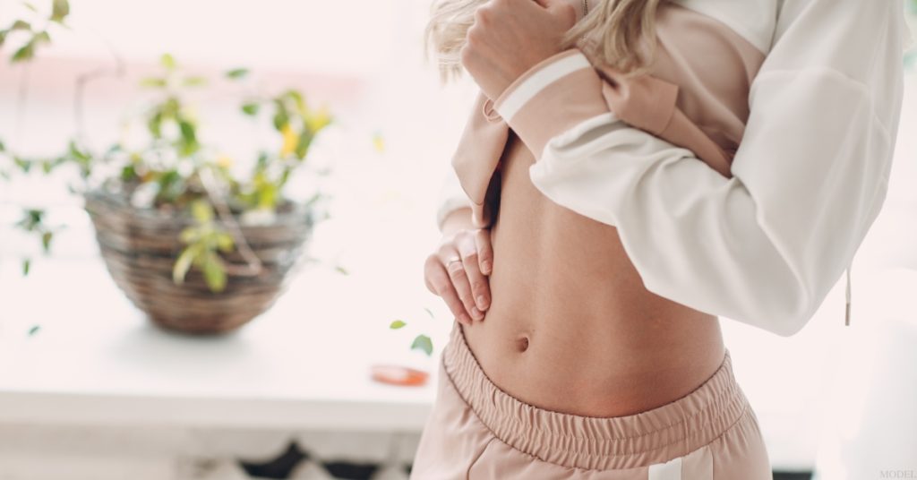 A woman in a white shirt and pink pants (model)