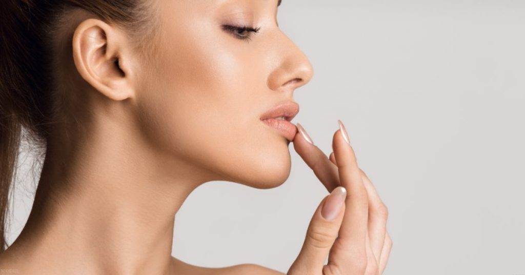 Close up of a woman touching her lips (model)